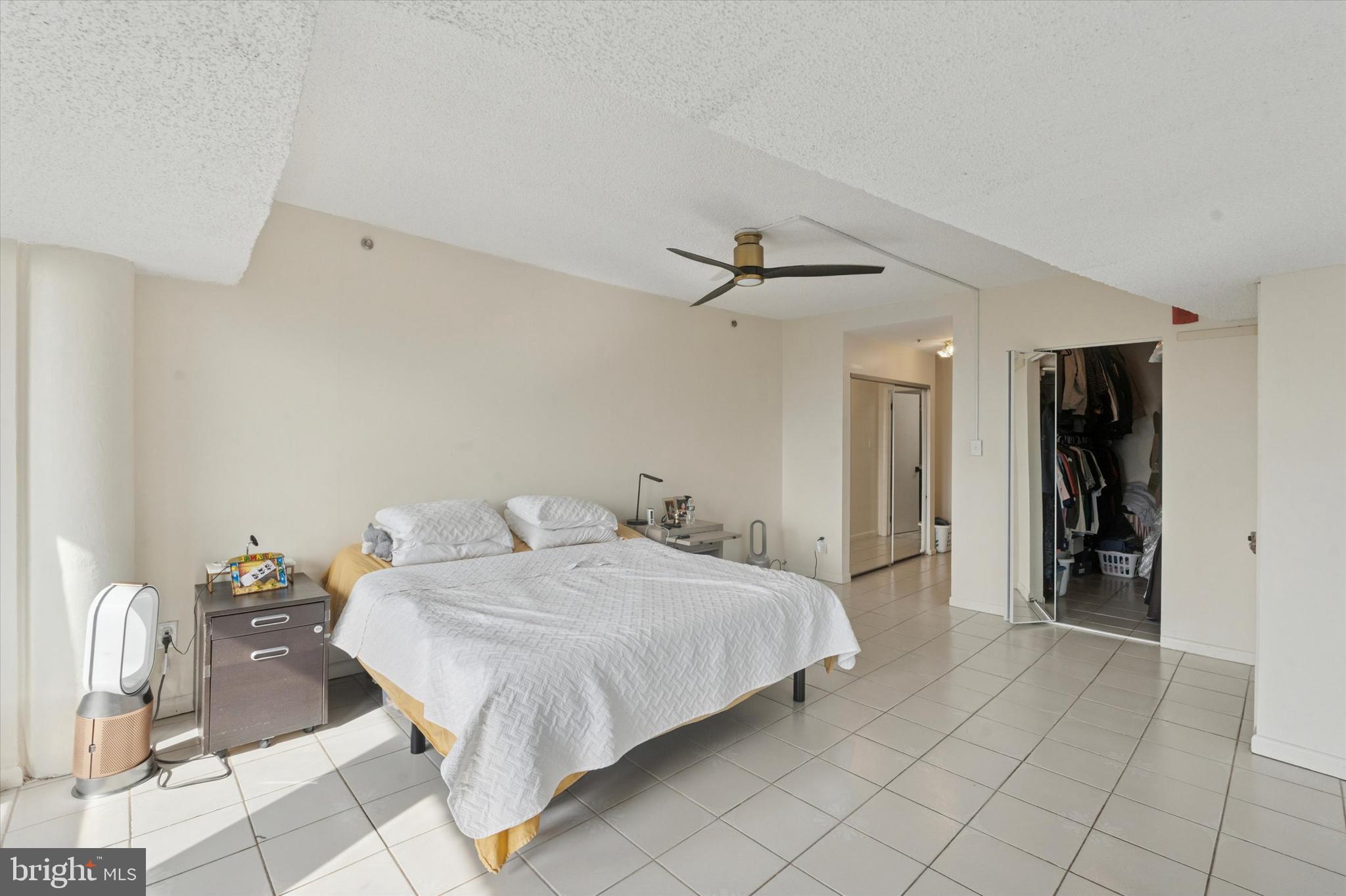 3900 West Ford Road, Unit 23B Philadelphia, PA 19131 - Photo 11 of 15 a bedroom with a bed and cabinets