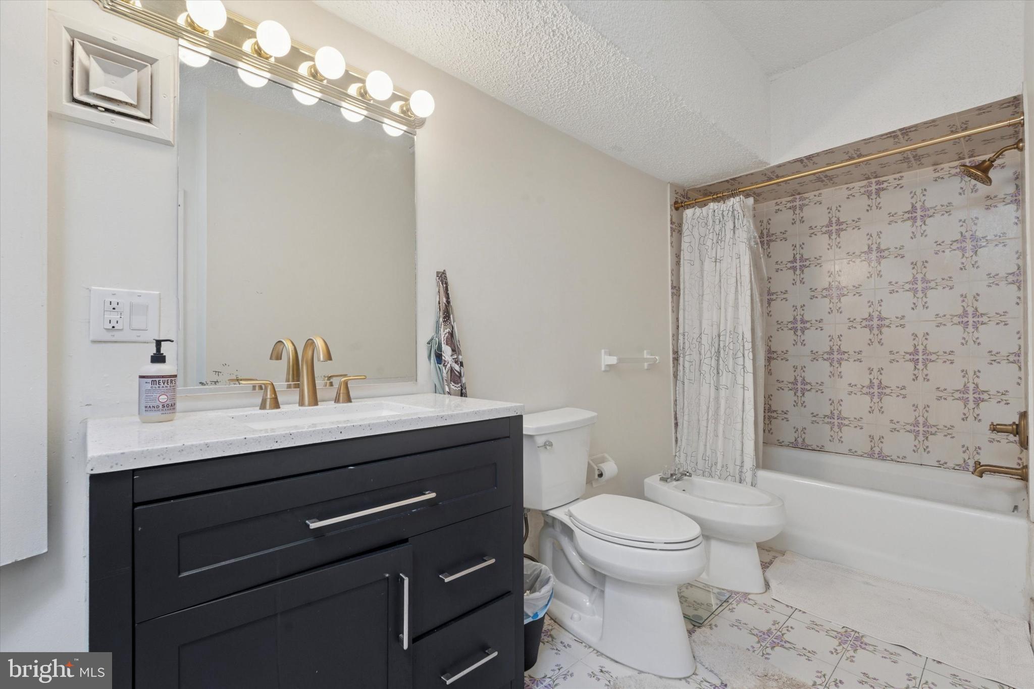 3900 West Ford Road, Unit 23B Philadelphia, PA 19131 - Photo 12 of 15 a bathroom with a sink a toilet and shower