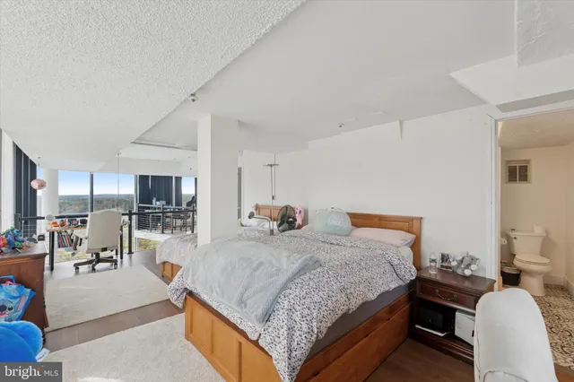 a bedroom with a bed a table and chairs