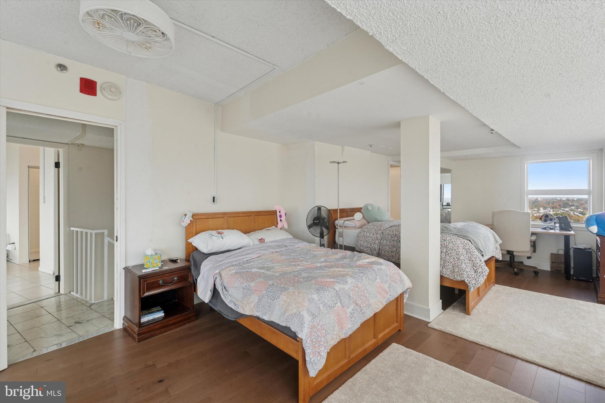 3900 West Ford Road, Unit 23B Philadelphia, PA 19131 - Photo 14 of 15 a bedroom with a bed and a view of kitchen