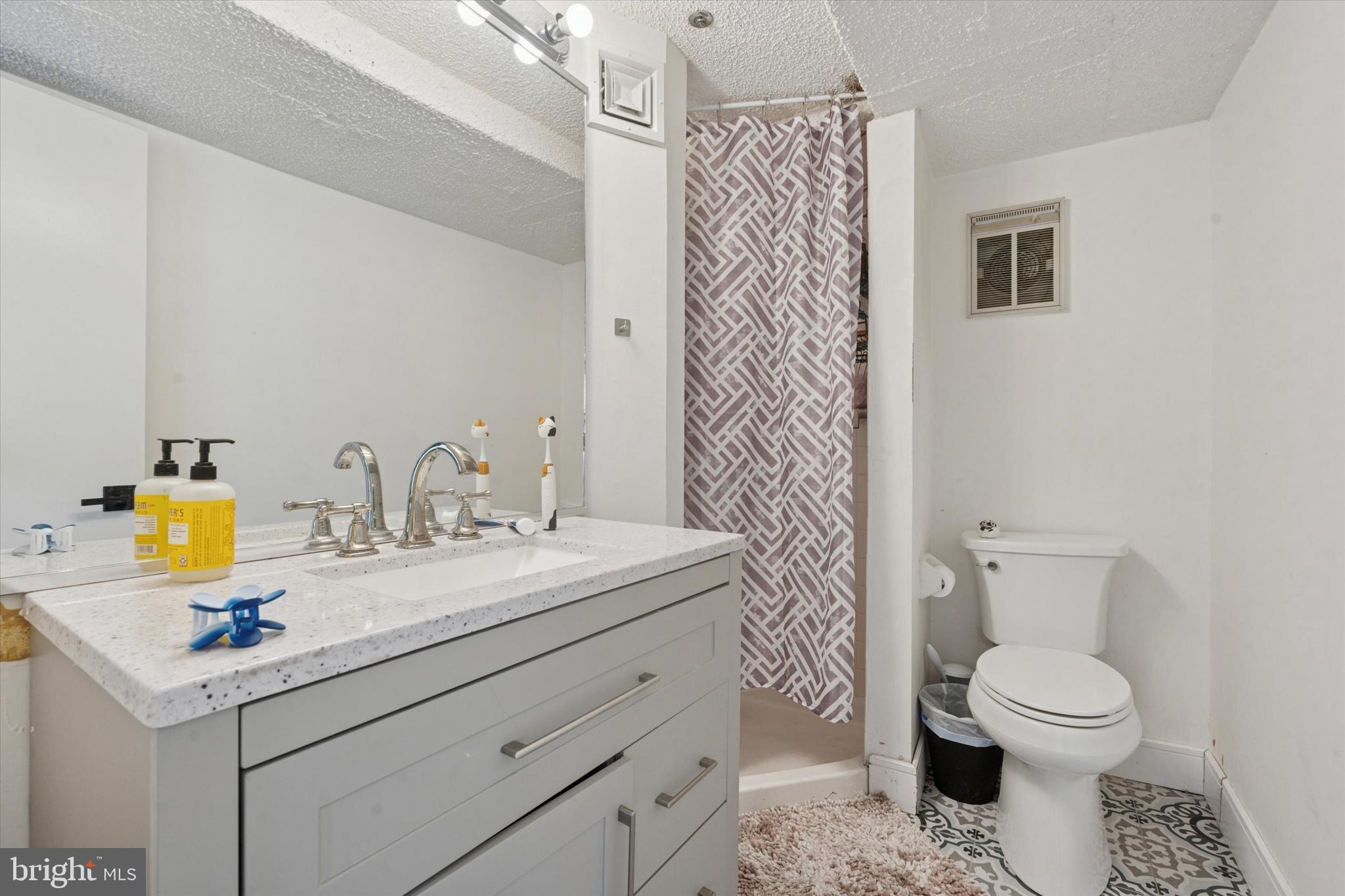 3900 West Ford Road, Unit 23B Philadelphia, PA 19131 - Photo 15 of 15 a bathroom with a sink toilet and shower