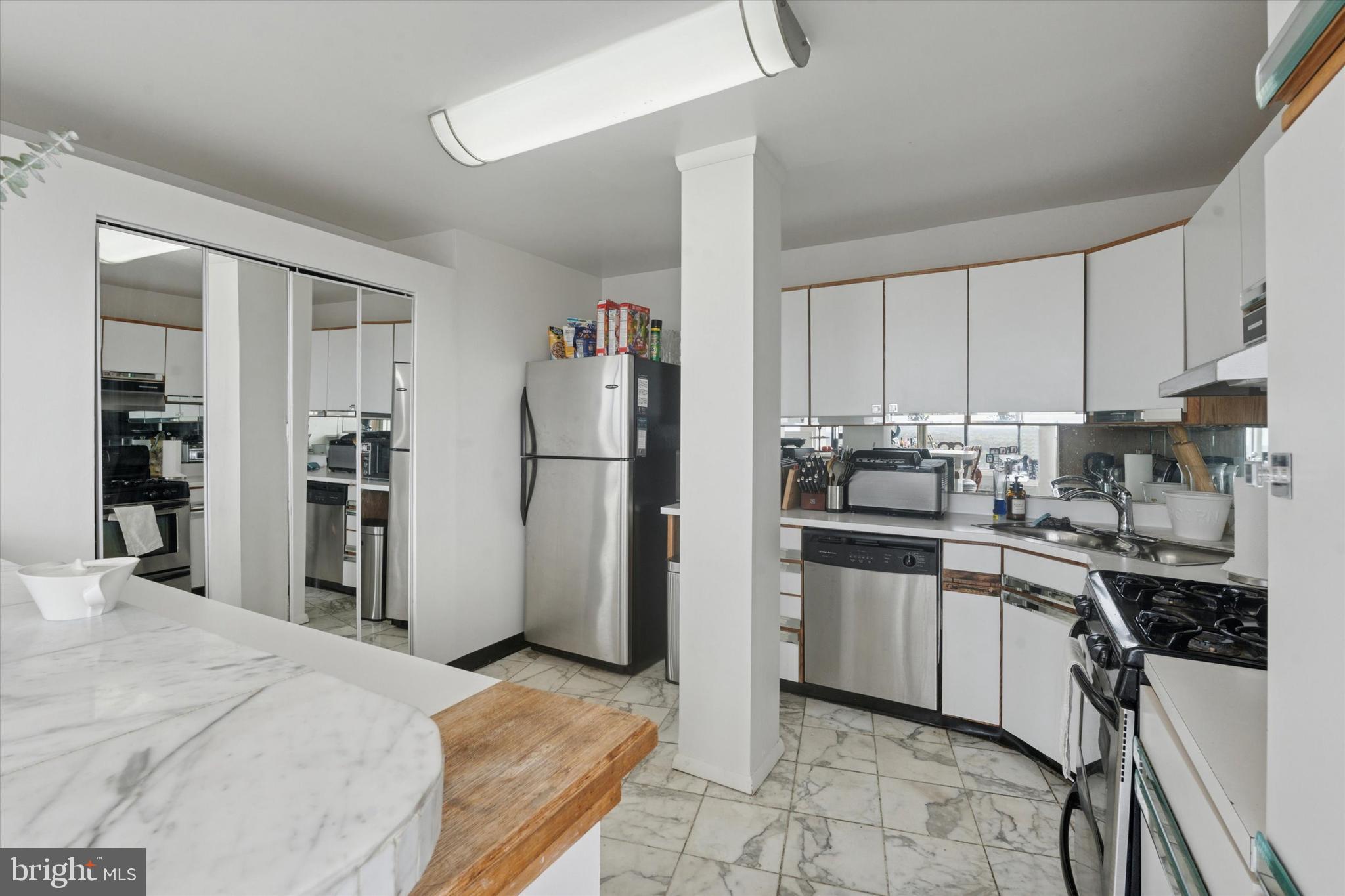 3900 West Ford Road, Unit 23B Philadelphia, PA 19131 - Photo 5 of 15 a kitchen with stainless steel appliances granite countertop a refrigerator stove a sink and dishwasher
