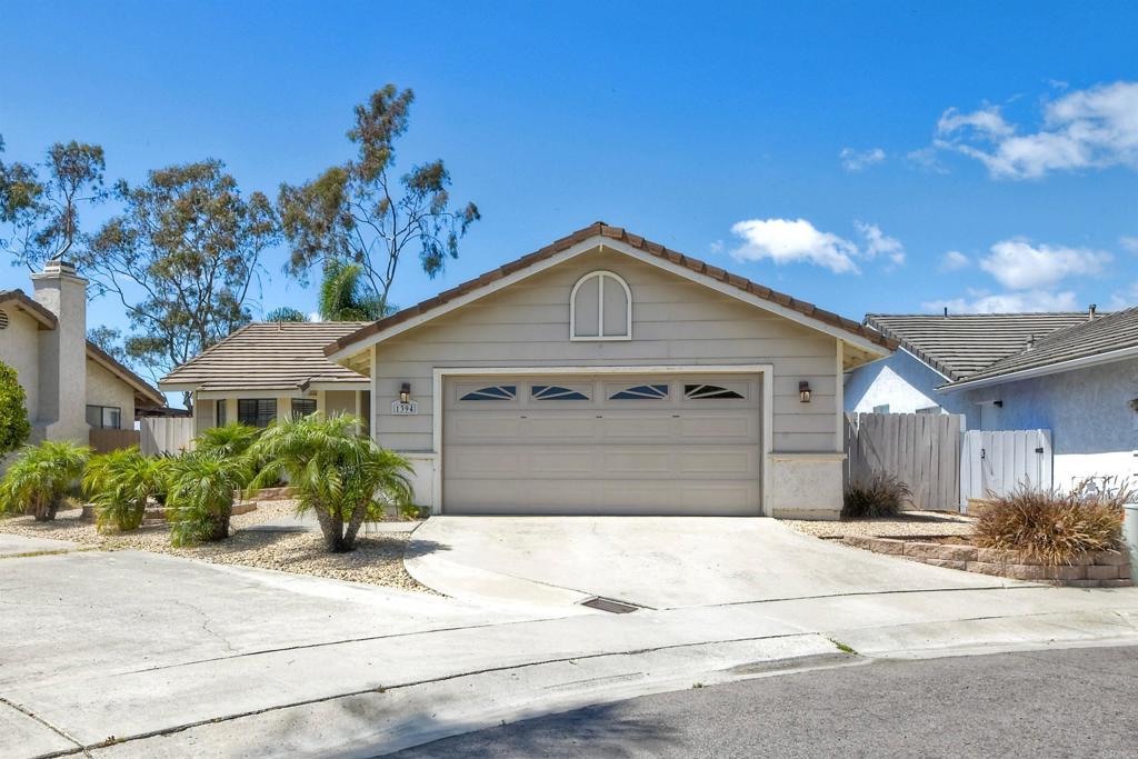 1394 Longfellow Road Vista, CA 92081 - Photo 37 of 50 a front view of a house with a yard and garage