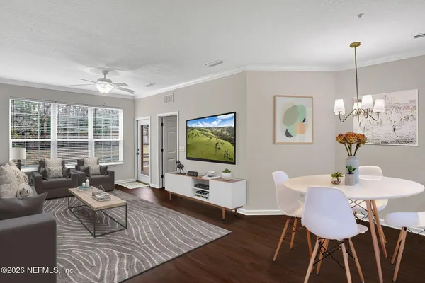 a living room with furniture and a flat screen tv