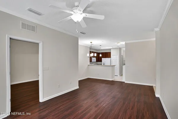 a view of a room with wooden floor