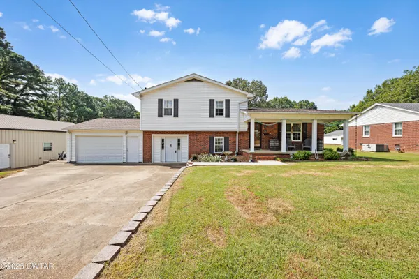 a front view of house with yard and swimming pool