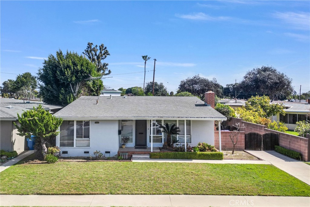 a front view of a house with a garden and plants