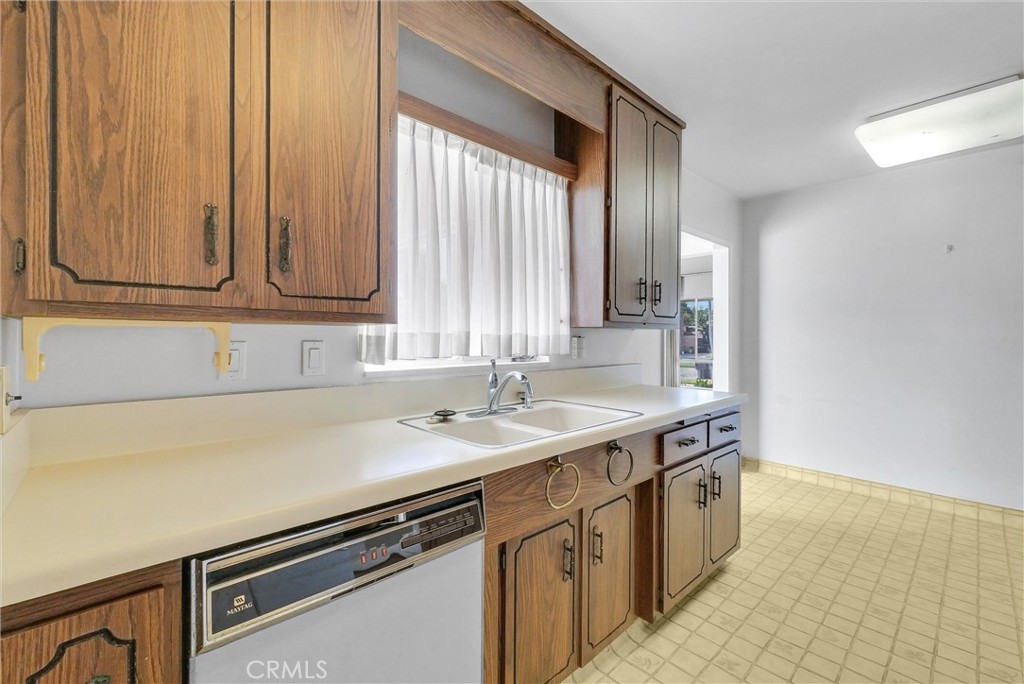 2680 Chatwin Avenue Long Beach, CA 90815 - Photo 11 of 33 a kitchen with a sink cabinets and window