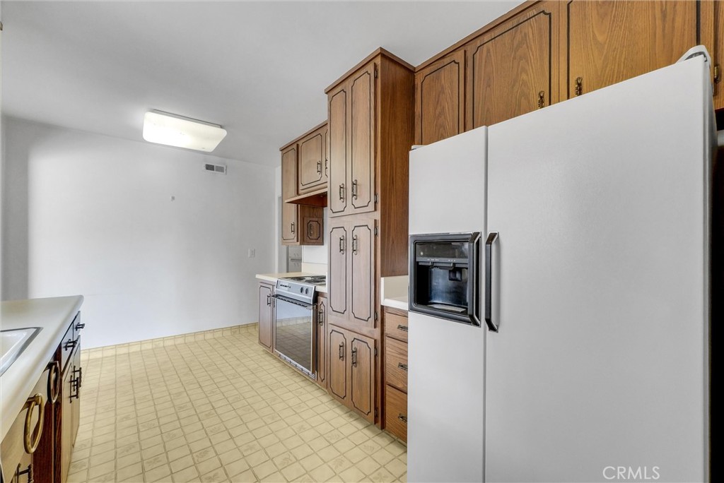 2680 Chatwin Avenue Long Beach, CA 90815 - Photo 12 of 33 a kitchen with stainless steel appliances a refrigerator and a stove top oven