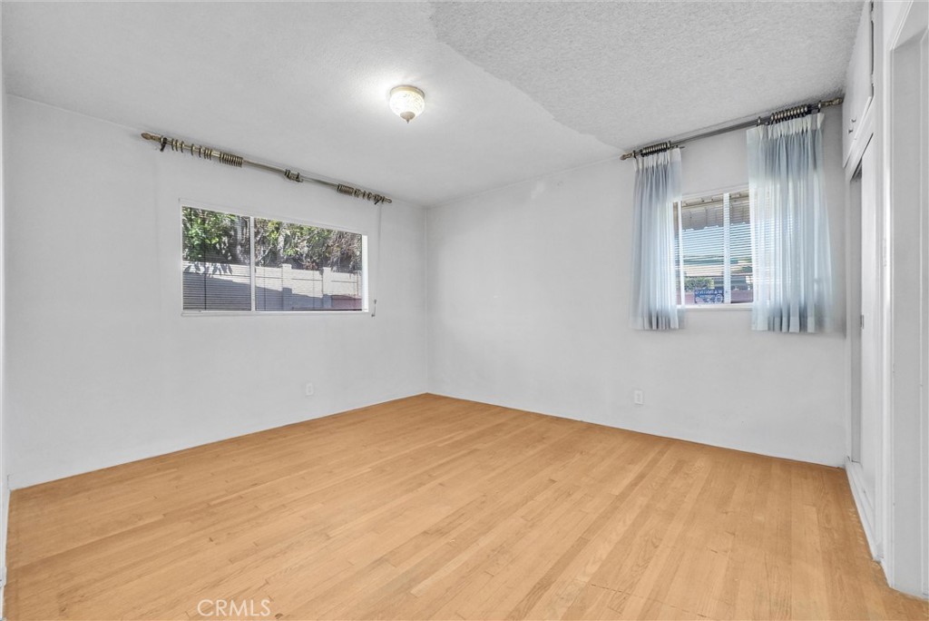 2680 Chatwin Avenue Long Beach, CA 90815 - Photo 14 of 33 a view of an empty room with wooden floor and a window