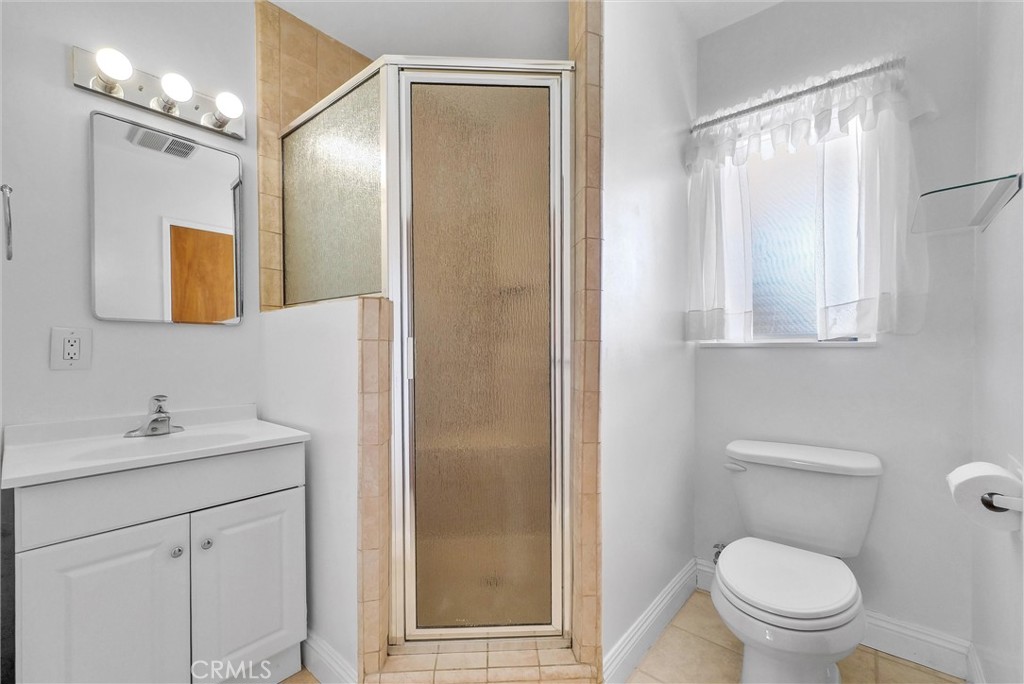 2680 Chatwin Avenue Long Beach, CA 90815 - Photo 16 of 33 a bathroom with a toilet a sink and a mirror