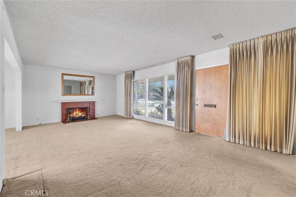 2680 Chatwin Avenue Long Beach, CA 90815 - Photo 5 of 33 a view of an empty room with a fireplace and a window