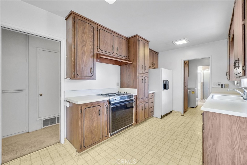 2680 Chatwin Avenue Long Beach, CA 90815 - Photo 9 of 33 a kitchen with stainless steel appliances granite countertop a refrigerator and a sink
