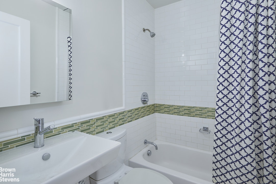 219 West 70th Street Manhattan, NY 10023 - Photo 11 of 20 a bathroom with a bathtub and a sink