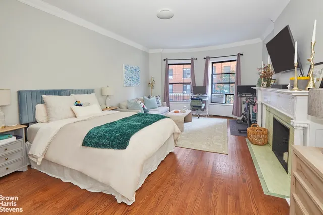 a bedroom with bed and a flat screen tv