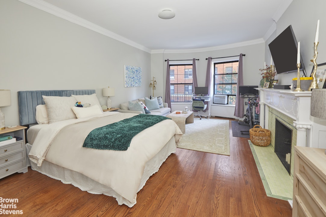 219 West 70th Street Manhattan, NY 10023 - Photo 12 of 20 a bedroom with bed and a flat screen tv