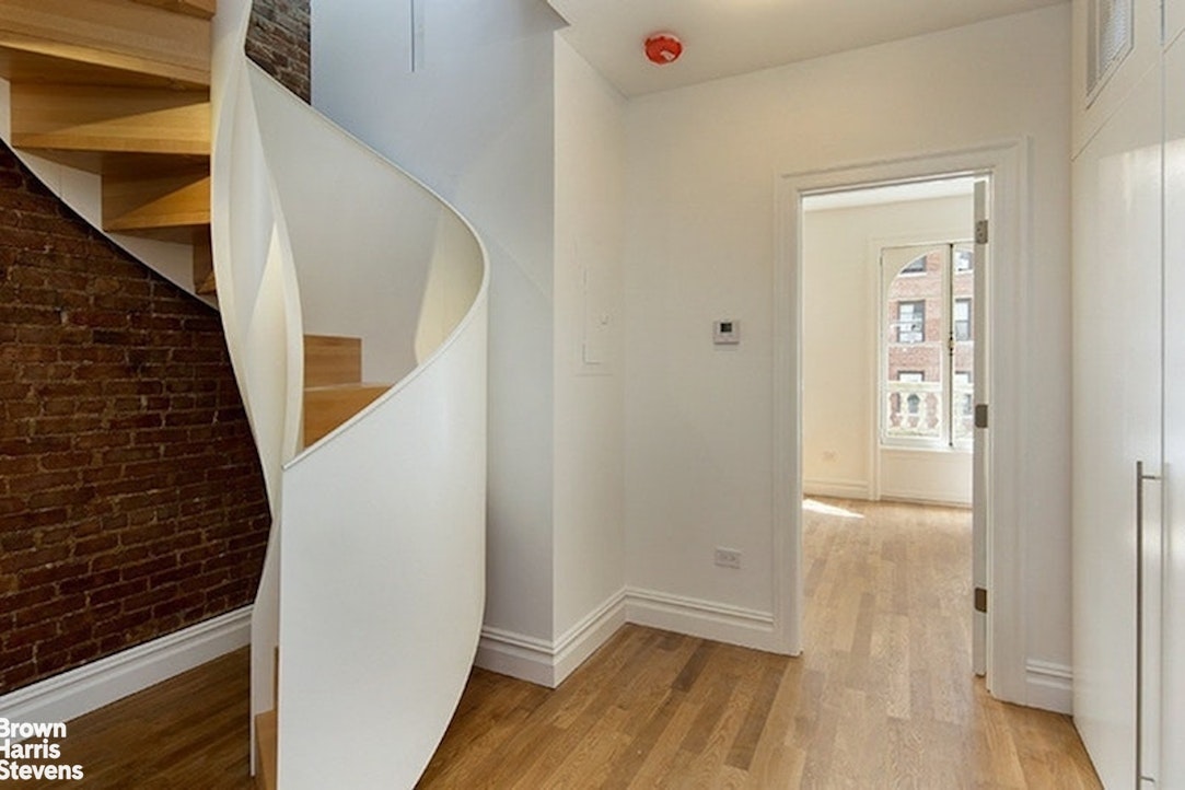 219 West 70th Street Manhattan, NY 10023 - Photo 13 of 20 a view of an entryway with wooden floor