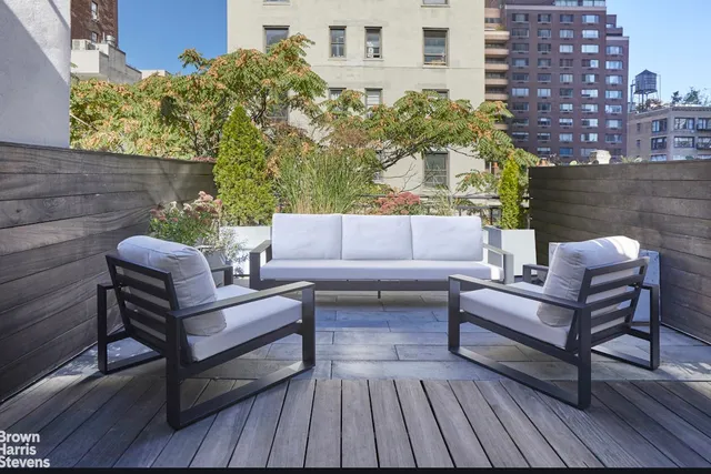 a view of living room with furniture and wooden floor