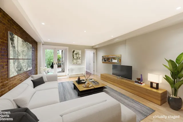 a living room with furniture fireplace and a large window