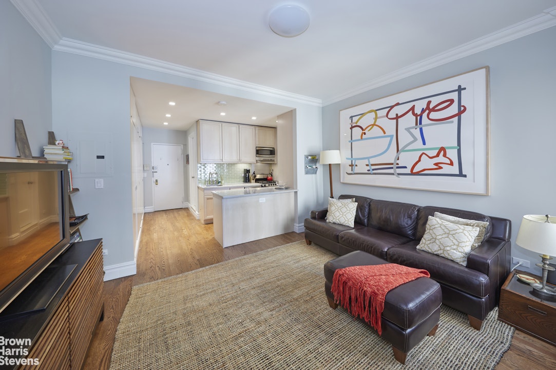 219 West 70th Street Manhattan, NY 10023 - Photo 9 of 20 a living room with furniture and a flat screen tv