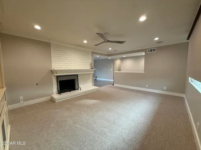an empty room with wooden floor and fireplace