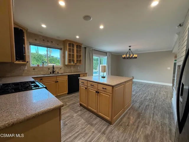 a kitchen with sink a stove and cabinets