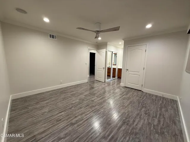 a view of a room with wooden floors