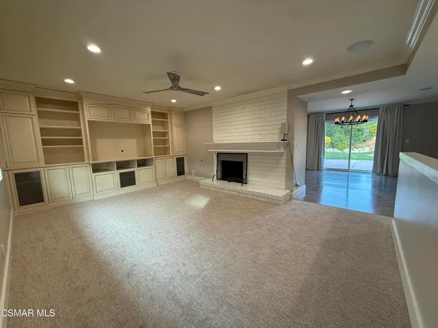 an empty room with furniture and a fireplace