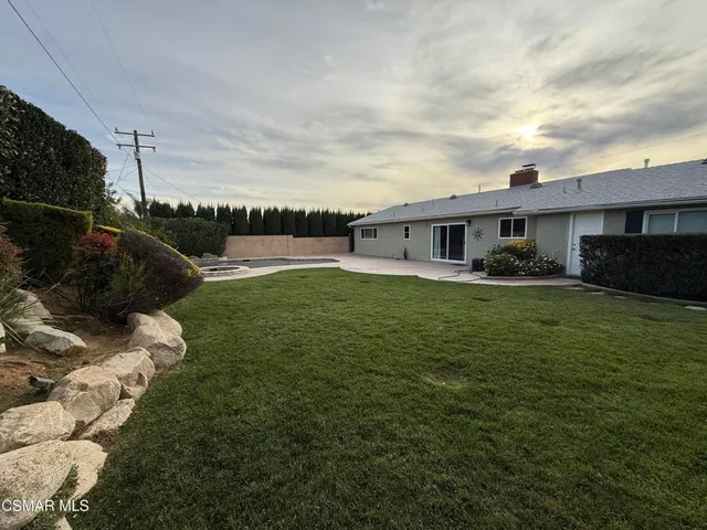 a view of a house with a yard