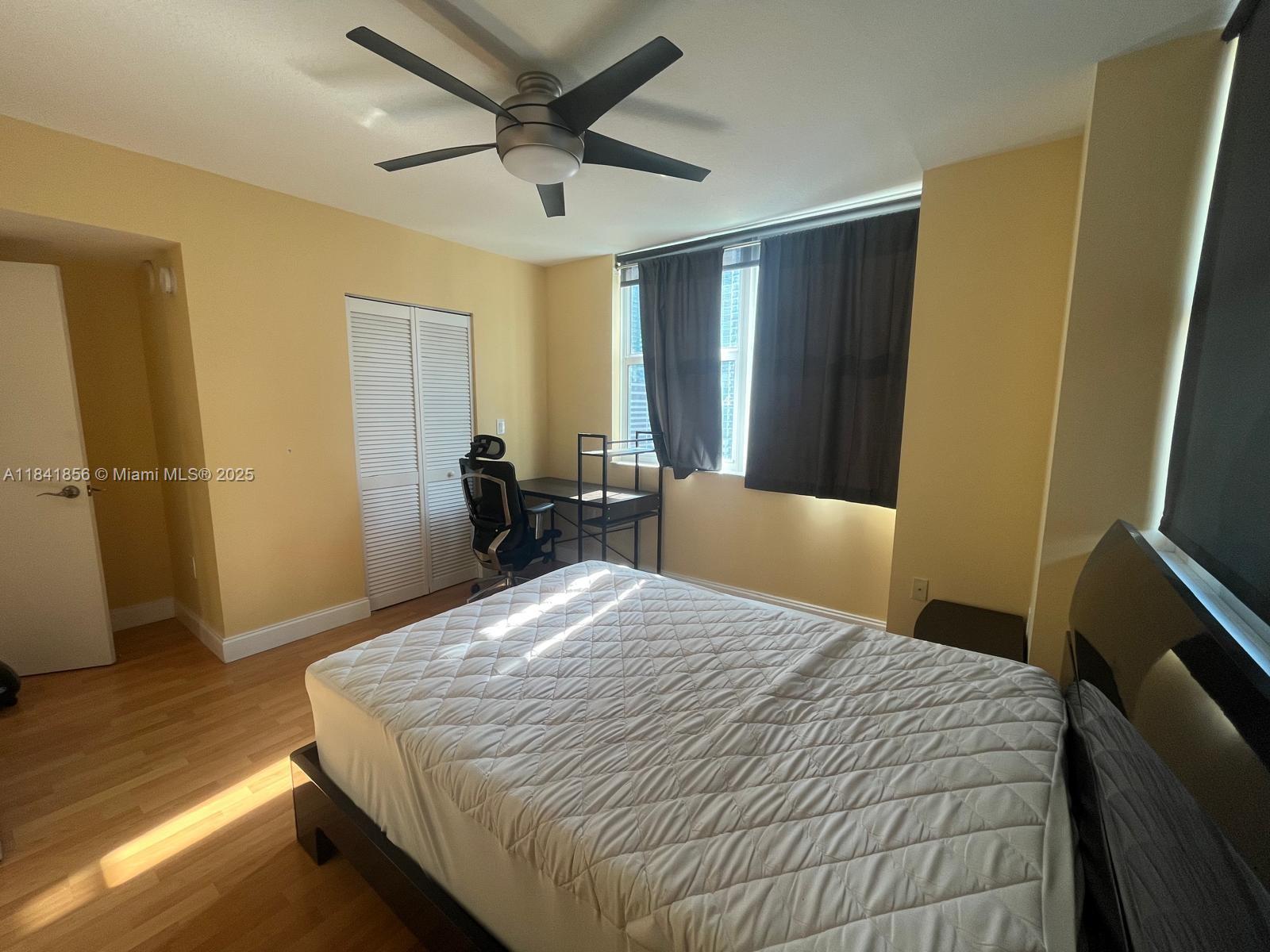 Brickell on the River Miami, FL 33131 - Photo 9 of 12 a bedroom with a bed and wooden floor