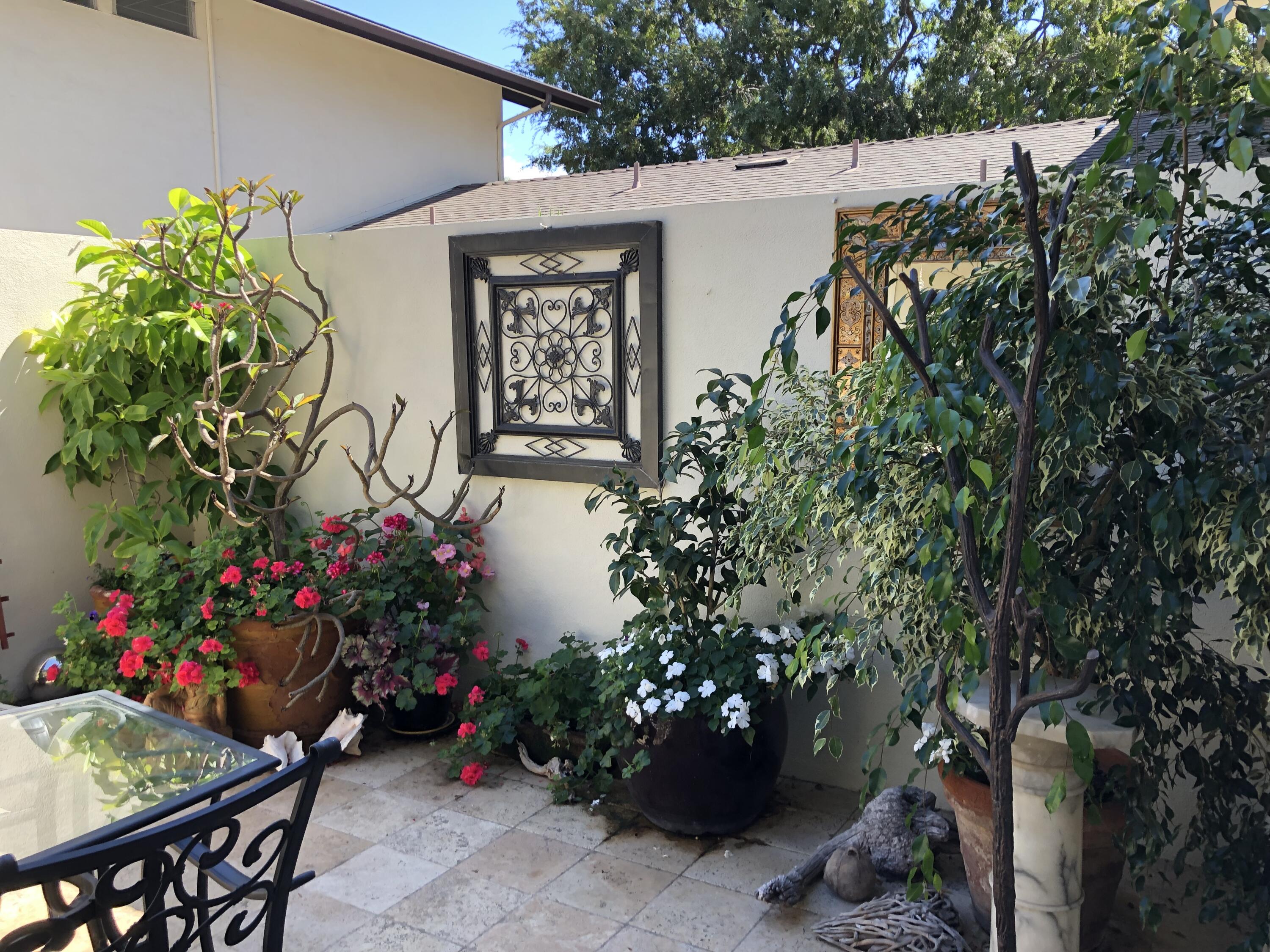 847 Cieneguitas Road Santa Barbara, CA 93110 - Photo 15 of 15 a bunch of flowers are sitting in front of house