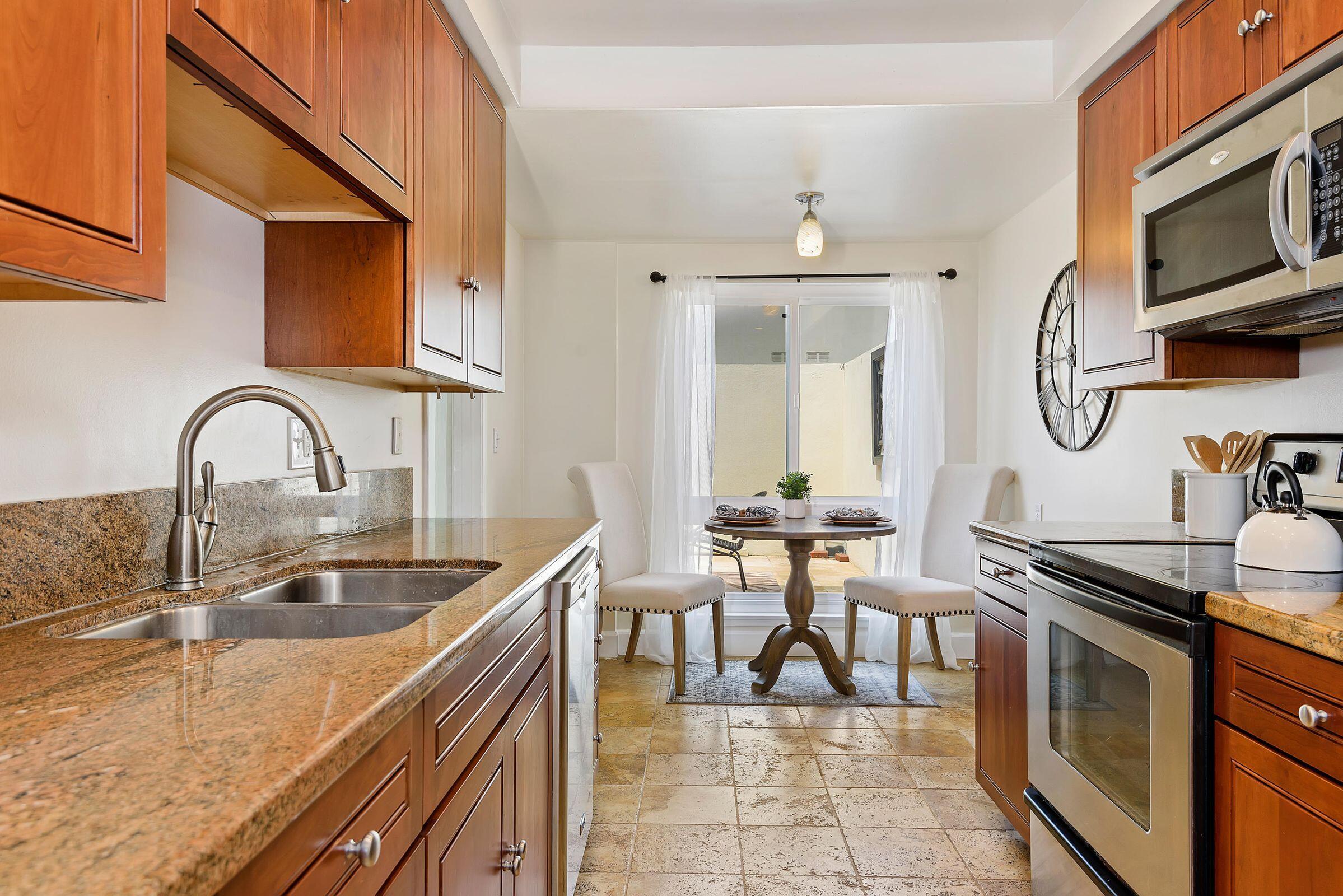 847 Cieneguitas Road Santa Barbara, CA 93110 - Photo 5 of 15 a kitchen with a sink a stove and cabinets