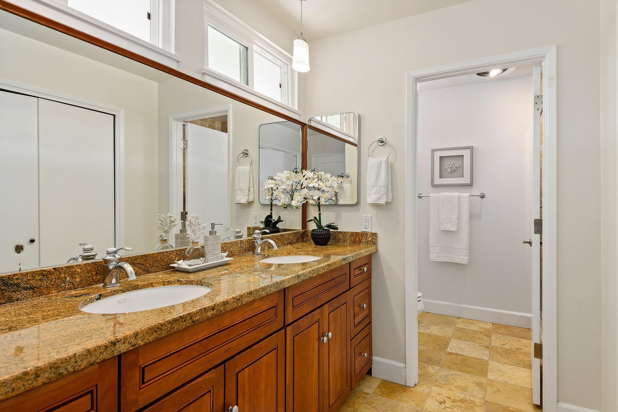 847 Cieneguitas Road Santa Barbara, CA 93110 - Photo 8 of 15 a bathroom with a granite countertop sink and a mirror