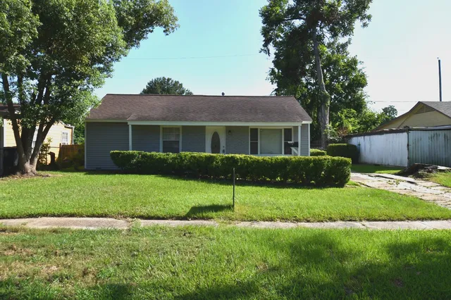 a view of a house with a yard and a garden