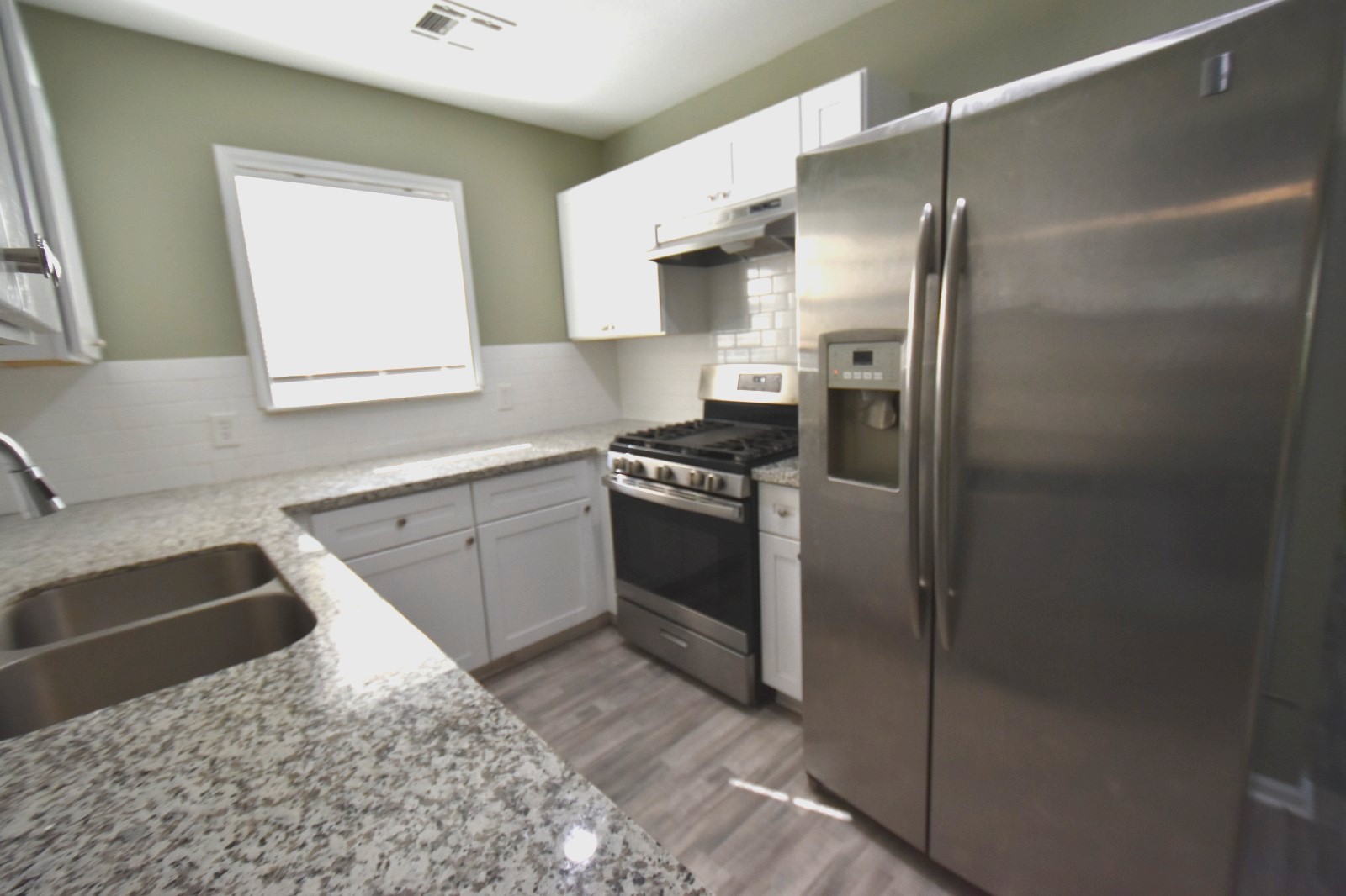 4038 Erby Street Houston, TX 77087 - Photo 6 of 19 a kitchen with a sink stove and refrigerator