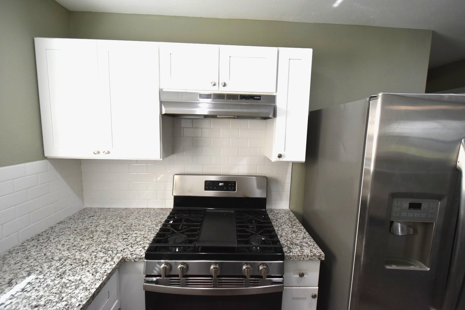 4038 Erby Street Houston, TX 77087 - Photo 7 of 19 a kitchen with granite countertop a stove and a refrigerator