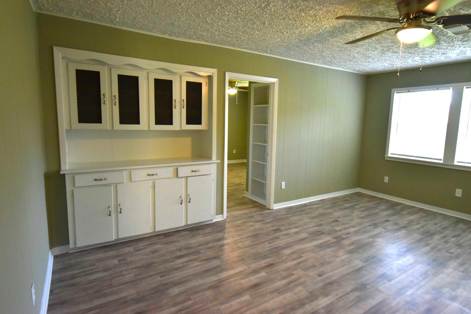 4038 Erby Street Houston, TX 77087 - Photo 8 of 19 an empty room with wooden floor and cabinet