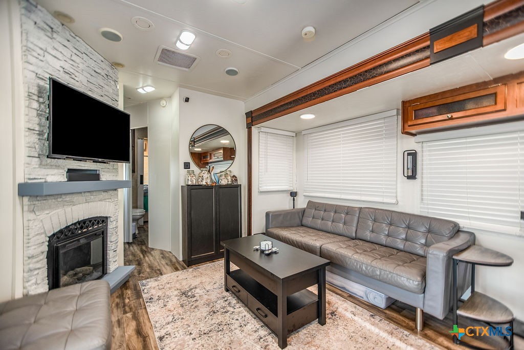 305 Zimmerman Road Port Lavaca, TX 77979 - Photo 19 of 33 a living room with furniture a flat screen tv and a fireplace