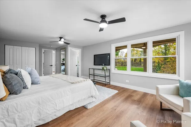 a spacious bedroom with a bed and a large window