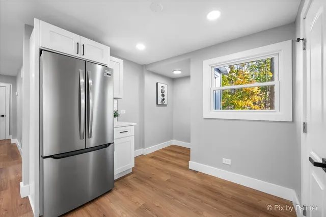 a kitchen with stainless steel appliances a refrigerator and a window