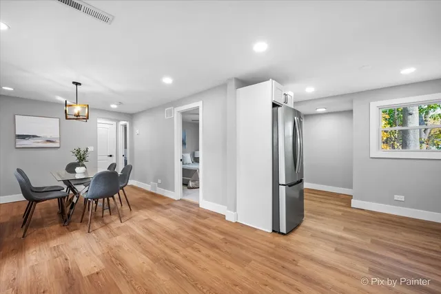 a view of a dining room with furniture and wooden floor