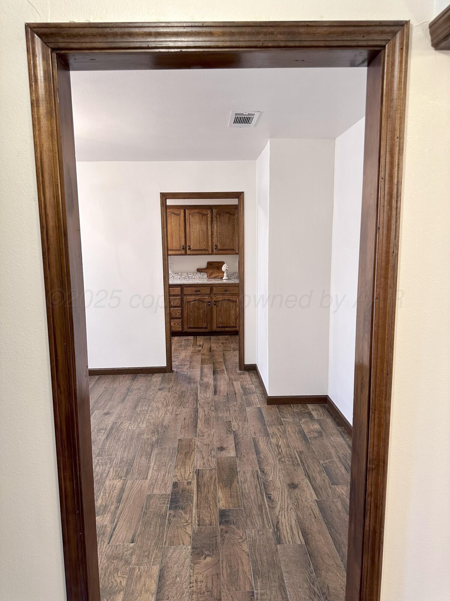 8205 Laredo Trail Amarillo, TX 79110 - Photo 23 of 120 a view of a kitchen from a hallway