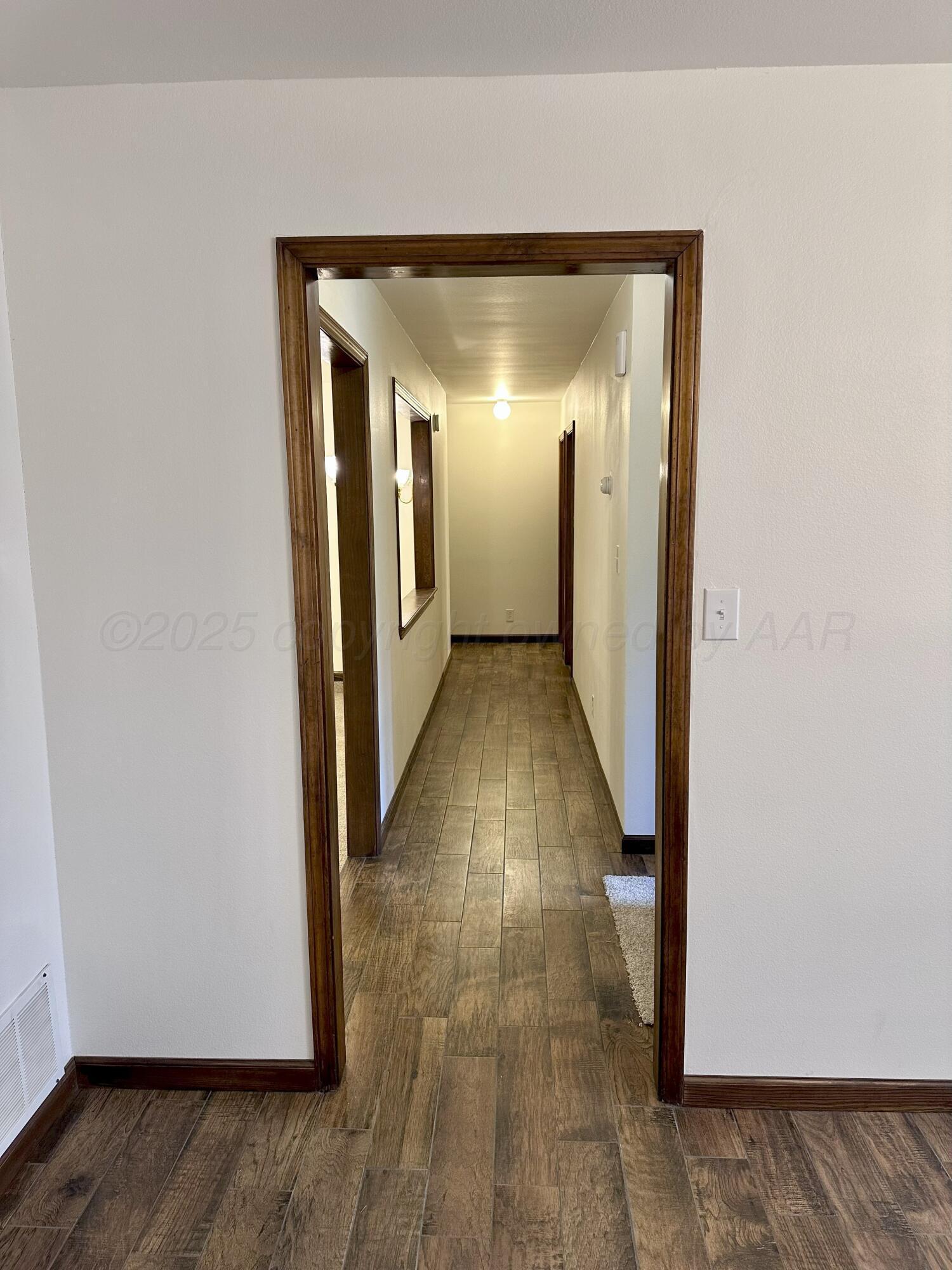 8205 Laredo Trail Amarillo, TX 79110 - Photo 48 of 120 a view of a hallway with wooden floor