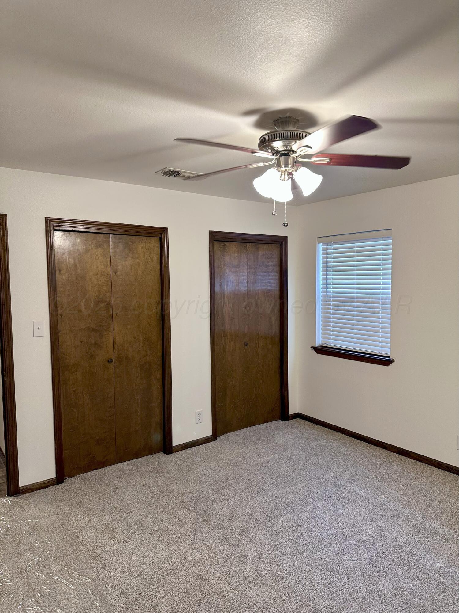 8205 Laredo Trail Amarillo, TX 79110 - Photo 59 of 120 a view of an empty room with a ceiling fan