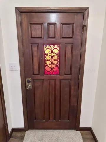 a view of an empty room with a chandelier fan