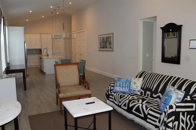 a view of a hallway with couch and a dining room