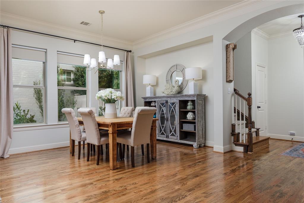 2205 State Boulevard McKinney, TX 75071 - Photo 6 of 40 Dining room featuring a chandelier, crown molding, recently refinished wood flooring, and arched walkways