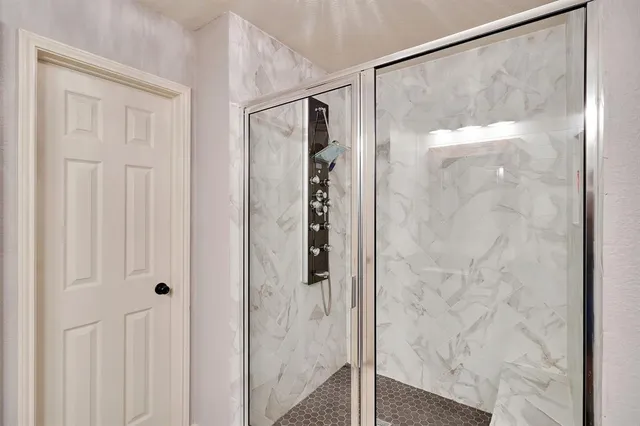 a bathroom with a glass shower door