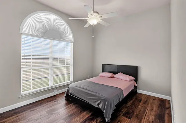 a bedroom with a large bed and a chandelier
