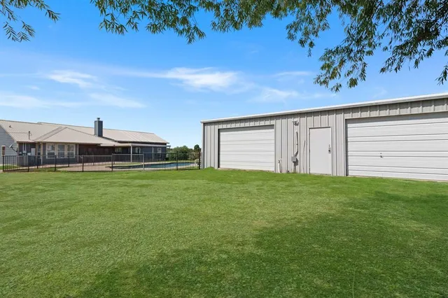a view of a house with a backyard